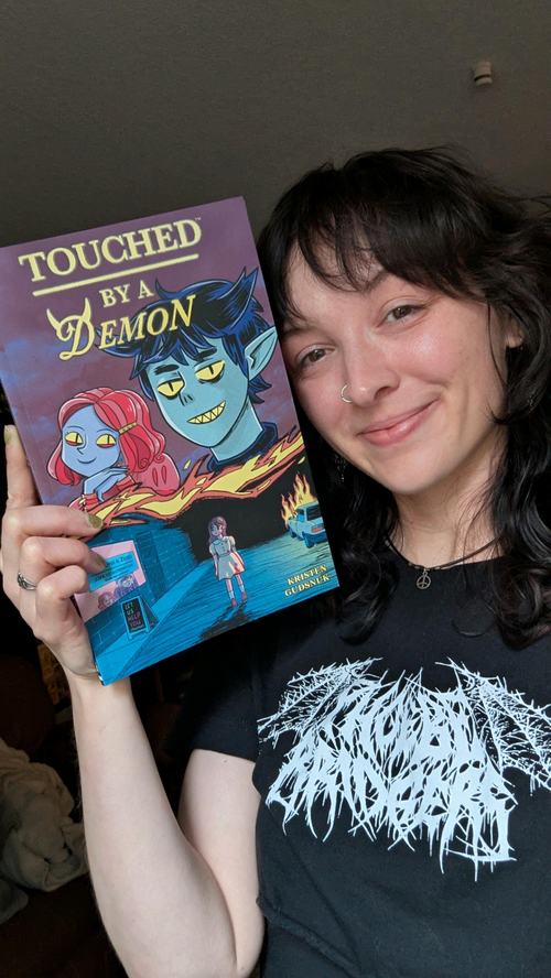Darby McCann holds a copy of Touched By a Demon.